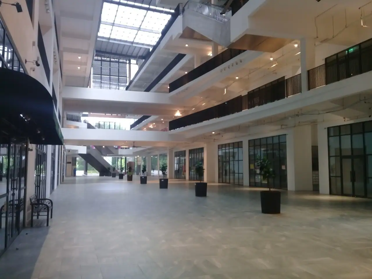 Bright multi-level retail atrium inside the Emporis podium