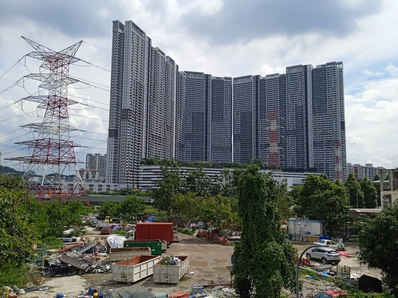 All five M Vertica towers side by side behind a transmission pylon