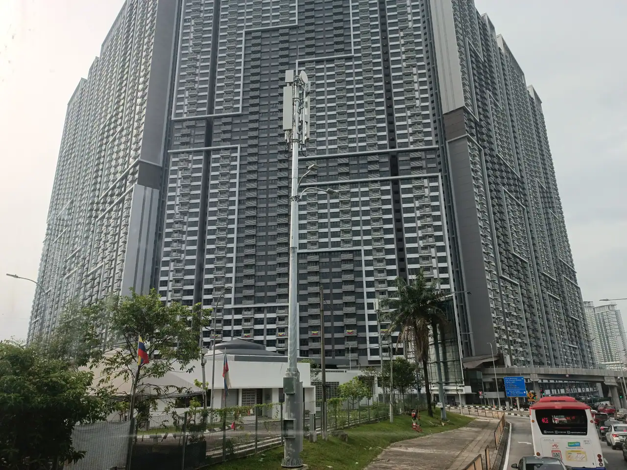 Looking up at a dark grey M Vertica tower from Jalan Cheras