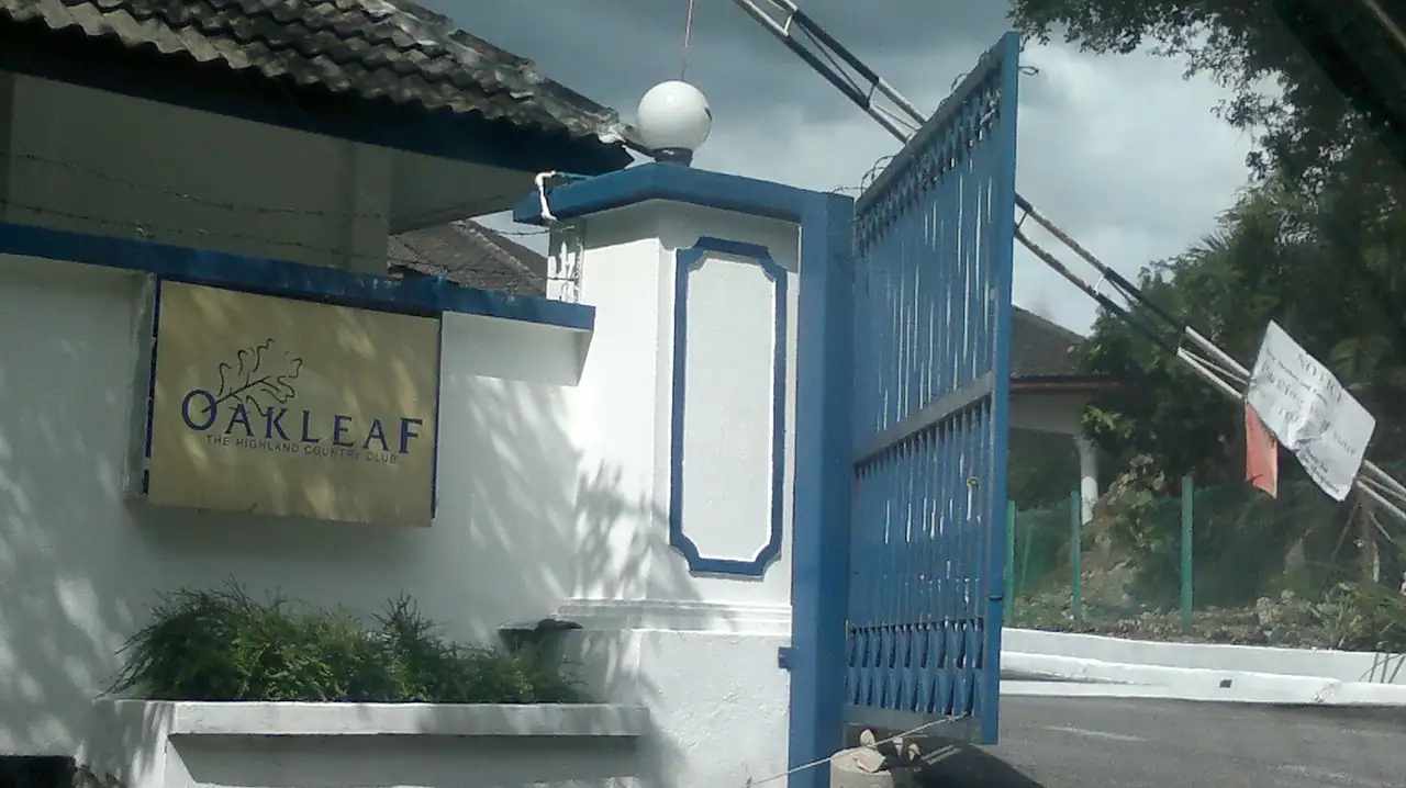 The Oakleaf gate pillar with the Oakleaf sign and an open blue gate