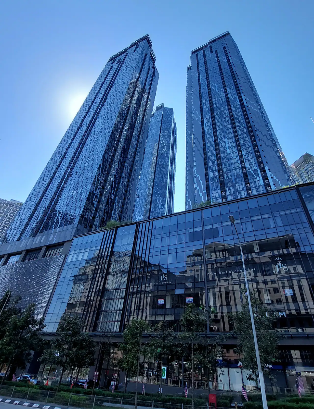 Glass facades of the Star Residences towers rising above the podium on Jalan Yap Kwan Seng