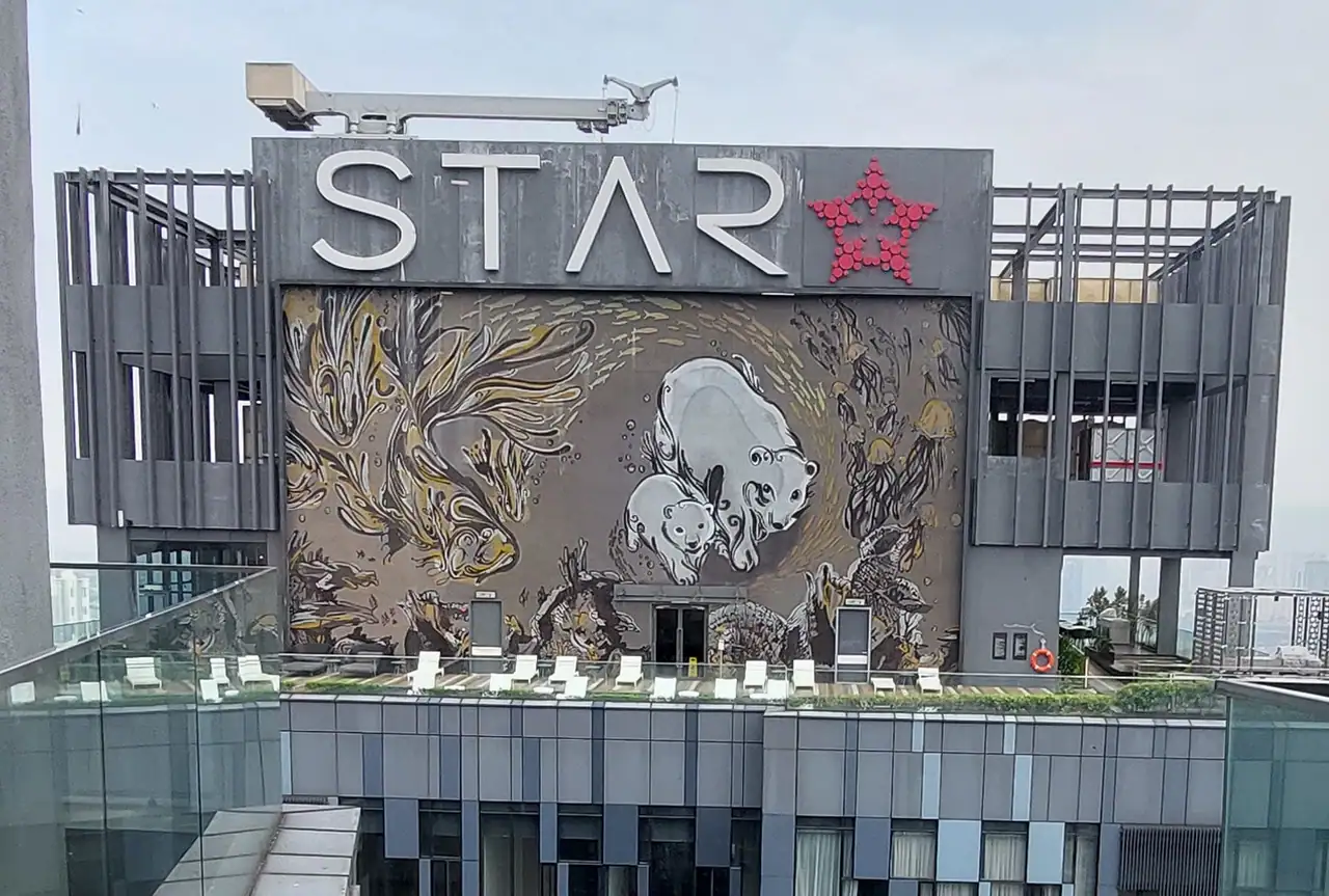 Large polar bear mosaic wall beneath the STAR sign on the Tower One rooftop deck