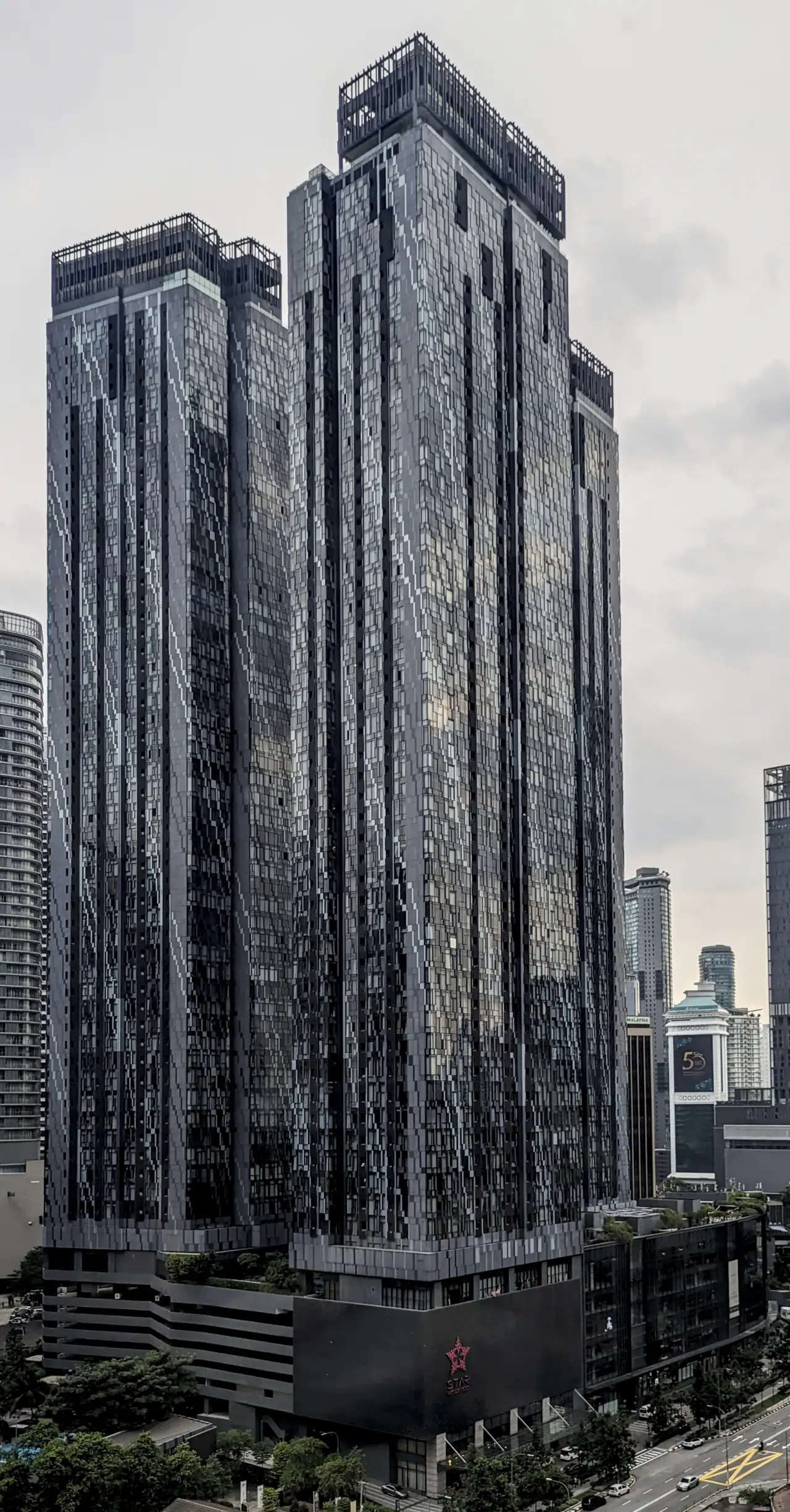 Star Residences Tower One, a dark glass tower, seen from across the city